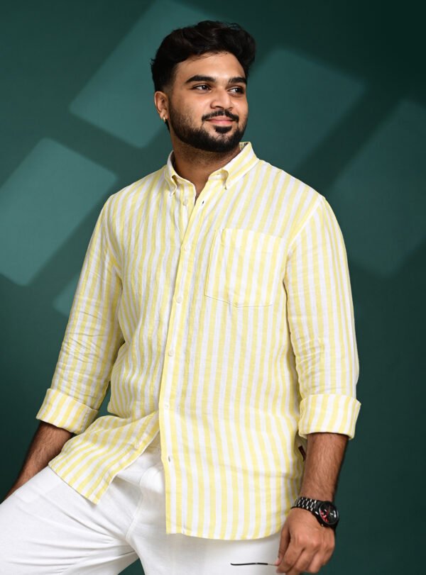 Home Close-up of a yellow striped pure linen shirt showing premium fabric texture and stitching
