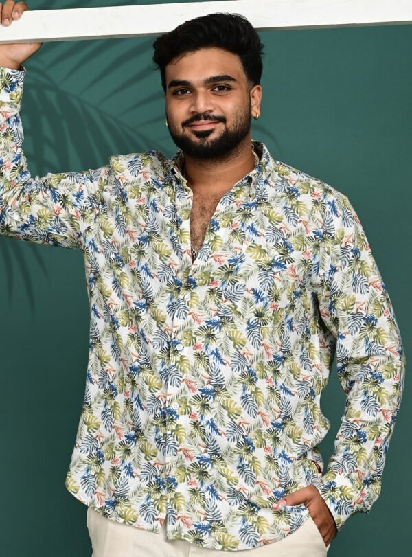 Home Men wearing a white tropical leaf print pure linen full sleeve shirt with premium button-down collar.
